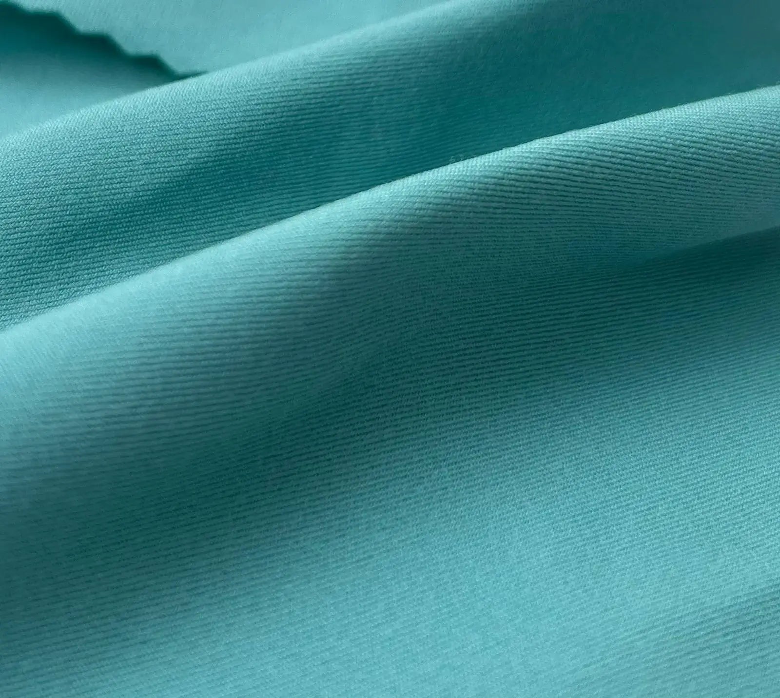 Close-up of teal fabric with visible texture